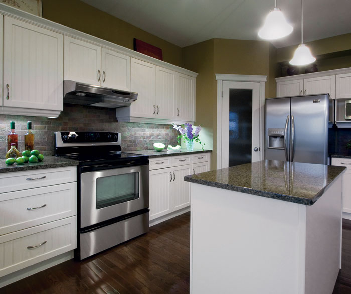 White kitchen cabinets with beadboard doors